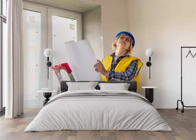 Woman Builder in the room of the house making repairs. Wall mural