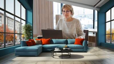 woman working on laptop in cafe, office Wall mural