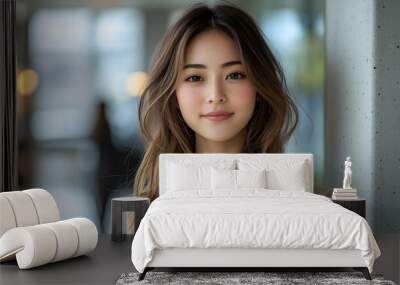 Portrait of a young Asian woman with long tousled hair and natural makeup, standing indoors with soft natural lighting
 Wall mural