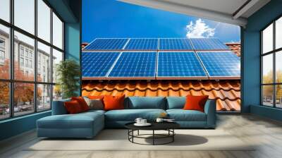 Solar panels on a tiled rooftop under bright sunlight Wall mural