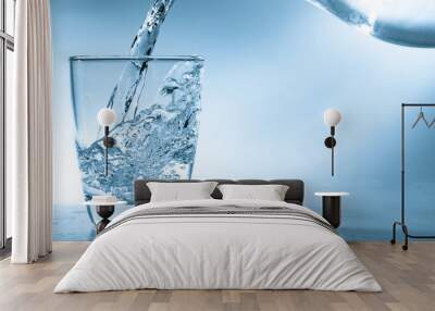 Drinking water is poured into a glass Wall mural