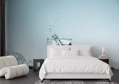 Water splash in glass. Drinking water concept Wall mural