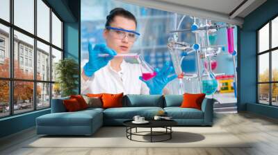 Young woman in chemical lab Young woman in chemical lab. cience professional pipetting solution into the glass cuvette. Wall mural