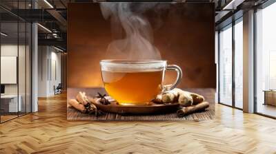 steaming ginger tea with cinnamon on a wooden surface Wall mural