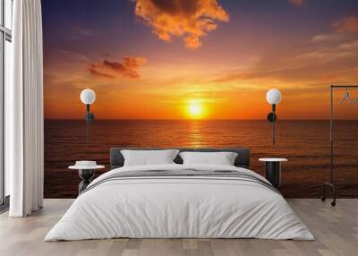 sunset sky in the evening with orange sunlight over the sea Wall mural