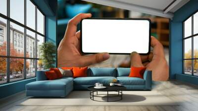 hand holding smartphone in horizontal. mix match transparent screen phone.  mobile game and video streaming. Wall mural