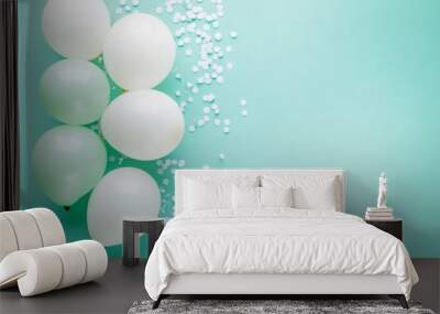 Pastel mint and white balloons on the left side, accompanied by light confetti, with plenty of free space on the right for text or design Wall mural