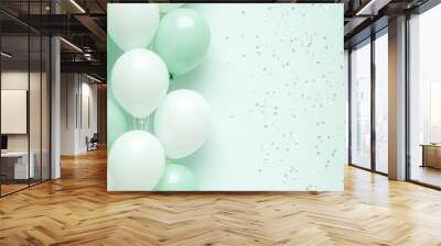 Pastel mint and white balloons on the left side, accompanied by light confetti, with plenty of free space on the right for text or design Wall mural