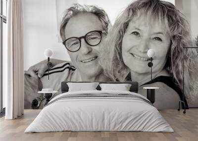 Black and white portrait of handsome mature middle aged family couple smiling embracing exchanging cuddles, romantic man and woman hugging getting closer enjoying moment of affection Wall mural