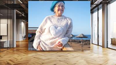 Freedom and happiness concept people with beautiful caucasian mature senior woman outdoor enjoying the destination place enjoying sea, beach, relax, blue sky. Copy space Wall mural