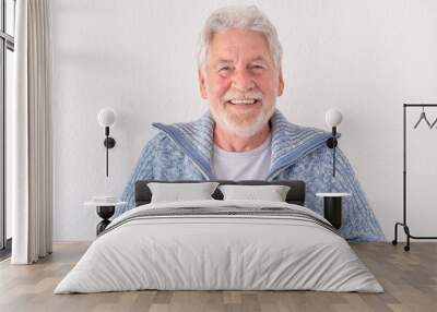 Portrait of happy bearded senior man in blue casual sweater looking at camera smiling standing on white background Wall mural