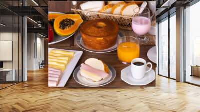 Mesa de café da manhã com vários alimentos, incluindo pães, doces, bolo, iogurte, chá, café, suco de laranja, presunto, queijo, mamão e maçã
 Wall mural