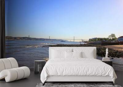 river coast in lisbon portugal, with the 25 de abril bridge in the background Wall mural