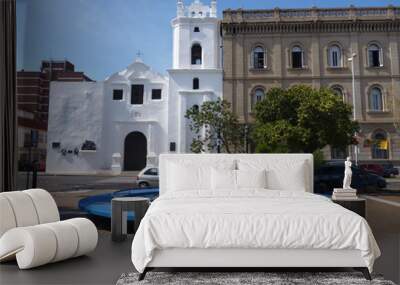 blue round fountain in front of a white church Wall mural