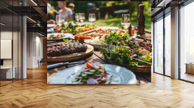 appetizing grilled meat and fresh salads on outdoor dinner table happy people enjoying backyard bbq party Wall mural