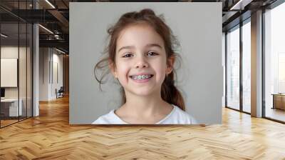 cheerful little girl with braces adorable smile dental health happiness studio portrait photo Wall mural