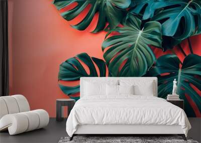 philodendron tropical leaves on coral color background minimal summer concept Wall mural