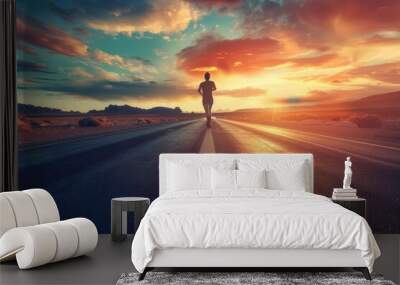 Silhouette of a determined runner on a desert road at dramatic sunset - Motivational sports concept Wall mural