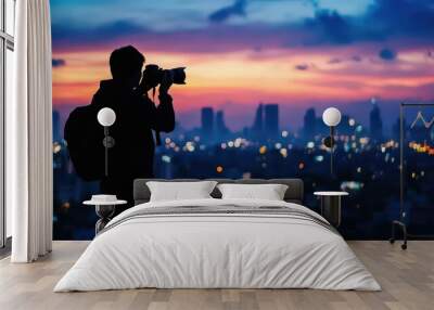 silhouette of photographer capturing vibrant cityscape at blue hour Wall mural