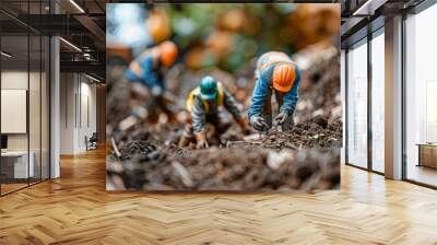 tiny workers in protective helmets and vests doing earthworks Wall mural