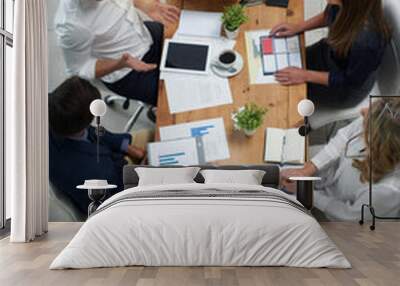 On a mission to realise their vision. High angle shot of a group of businesspeople having a meeting in an office. Wall mural