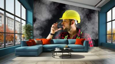 Tired Construction Worker drinks water.  There is dust everywhere. Wall mural