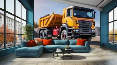 Large mining dump truck at the construction site. Powerful modern equipment for the delivery and transportation of bulk cargo. Construction site. Rental of construction equipment. Wall mural