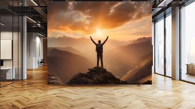 Man with arms up celebrating on top of the mountains - Hiker enjoying freedom on a hill at sunset - Freedom, sport, success and mental health concept Wall mural