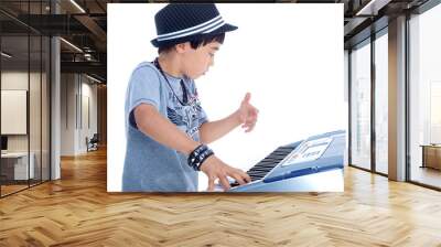 child playing musical keyboard isolated on white background Wall mural