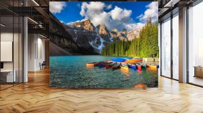 Morning light on colorful canoes along the shore of Moraine Lake, Banff National Park, Alberta, Canada. Wall mural