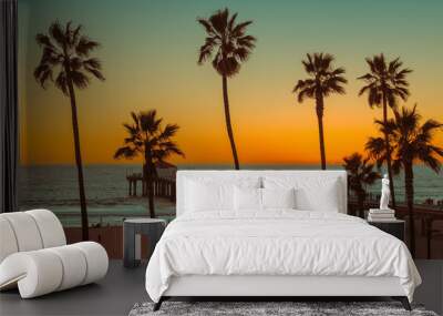 Palm trees and Pier on Manhattan Beach at sunset in California, Los Angeles, USA.  Wall mural