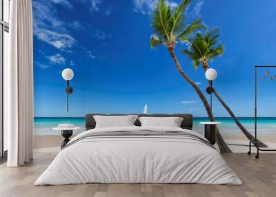 Palm trees in Paradise white sand beach, blue sky and sailboat in tropical sea in exotic island. Wall mural