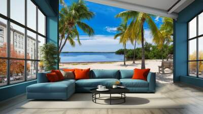 Palm trees on a tropical beach with bench in shadow in Florida Keys. Wall mural