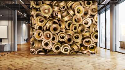 An abstract backround of yellow cadmium coated steel rings. Closeup with selective focus. Wall mural