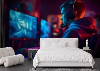 young caucasian gamer with headset playing video games with computer and multiple screens lit with saturated neon lights, neural network generated photorealistic image Wall mural