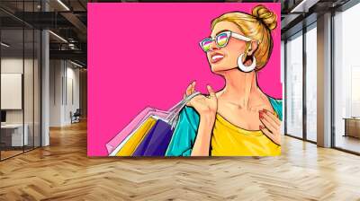 Amazed young smiling sexy woman in glasses with shopping  bags in comic style.  Pop Art  wow girl looks somewhere. Advertising poster with surprised magazine cover female model. Wall mural