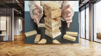 woman hand prevent wood blocks game, Concept Risk of management and strategy plan, growth business success process and team work Wall mural