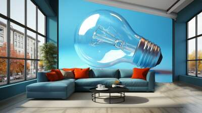 A close-up of a glass light bulb on a vibrant blue background, symbolizing innovation and creativity in lighting design. Wall mural