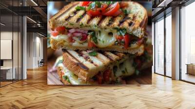 A delicious grilled cheese sandwich with melted cheese, grilled tomatoes and basil. Wall mural