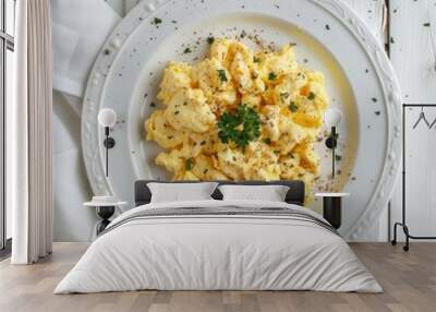 A plate of scrambled eggs garnished with parsley and black pepper. Wall mural