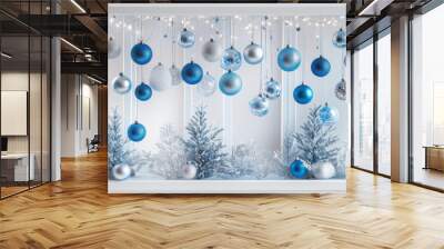 festive winter window display features blue and silver Christmas ornaments hanging above frosted pine trees, creating serene holiday atmosphere Wall mural