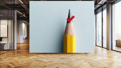 yellow pencil with red checkmark on its tip symbolizes goal setting and achievement. minimalistic design emphasizes focus and precision Wall mural