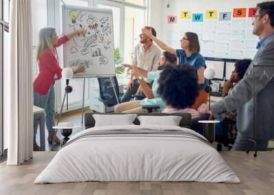 A group of young employees is discussing at a meeting in the office. Employees, job, office Wall mural