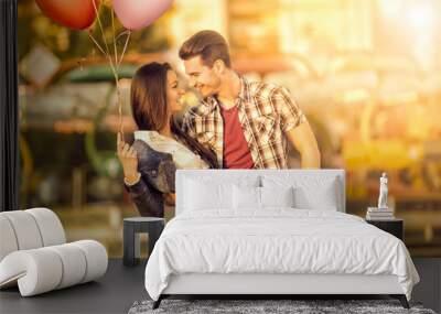 Affectionate couple having fun in amusement park Wall mural