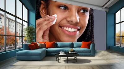 African girl cleaning make up from skin Wall mural