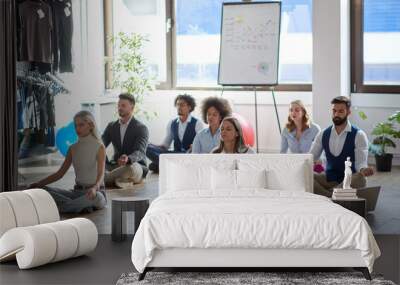 business colleagues meditating at work, sitting on the floor. modern, business, meditation concept Wall mural