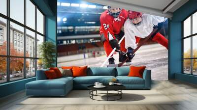 children hockey player handling puck on ice. Wall mural