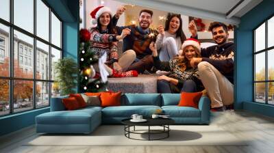 Christmas sparklers- people enjoying party on Christmas. Wall mural