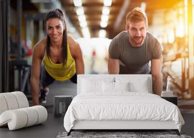 Couple doing exercise for arms Wall mural