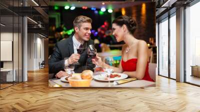 couple in restaurant toasting Wall mural